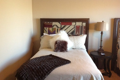 Mid-sized country guest bedroom in Phoenix with beige walls, carpet and no fireplace.
