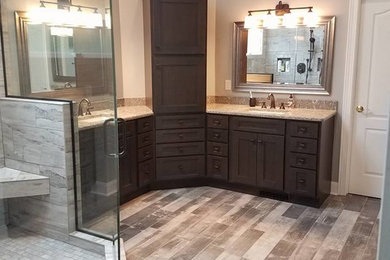 Corner shower - large transitional master gray tile and porcelain tile porcelain tile corner shower idea in Cleveland with flat-panel cabinets, dark wood cabinets, gray walls, an undermount sink and quartz countertops