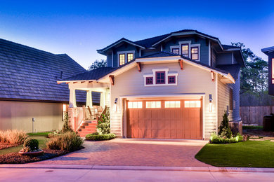Example of an arts and crafts green two-story wood exterior home design in Houston
