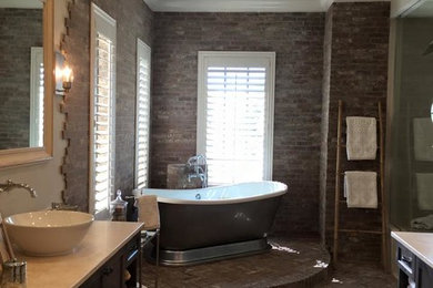 Example of a large classic master beige tile and ceramic tile dark wood floor and brown floor bathroom design in Tampa with recessed-panel cabinets, dark wood cabinets, beige walls, a vessel sink, quartzite countertops and a hinged shower door