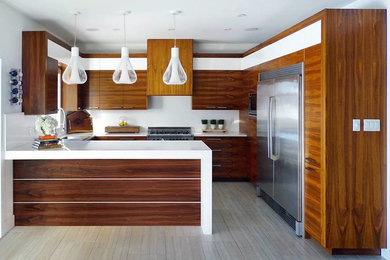 Inspiration for a mid-sized modern u-shaped separate kitchen in Toronto with quartz benchtops, a drop-in sink, flat-panel cabinets, medium wood cabinets, white splashback, stainless steel appliances, a peninsula and porcelain floors.