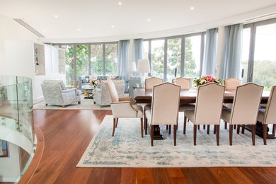 Mid-sized transitional dining room in Sydney with white walls, medium hardwood floors and no fireplace.