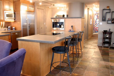 Mid-sized transitional galley slate floor and multicolored floor eat-in kitchen photo in Charlotte with recessed-panel cabinets, light wood cabinets, stainless steel appliances, an island, gray countertops, an undermount sink and concrete countertops
