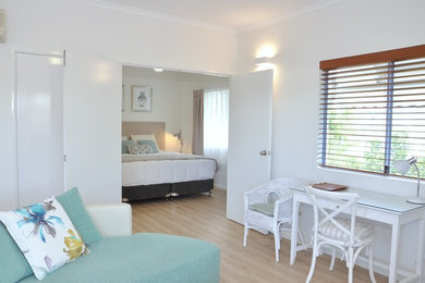 Design ideas for a beach style master bedroom in Sunshine Coast with white walls, vinyl floors and beige floor.
