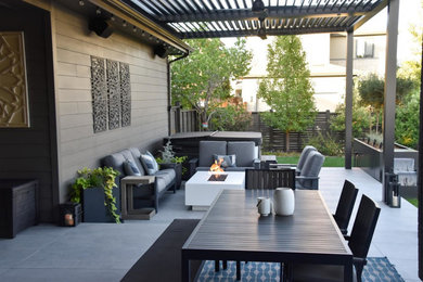 Inspiration for a modern backyard concrete patio remodel in Denver with a pergola
