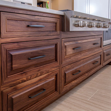 Select walnut island with Wolf gas cook top and built in microwave.
