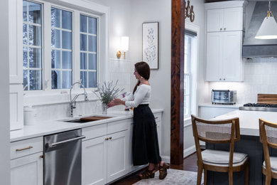 Kitchen - large transitional u-shaped medium tone wood floor kitchen idea in DC Metro with a single-bowl sink, flat-panel cabinets, quartz countertops, white backsplash, porcelain backsplash, stainless steel appliances, an island and white countertops