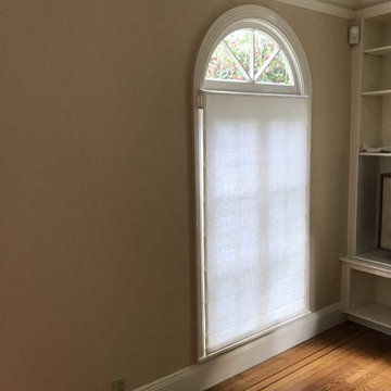 Roman shades mounted below arch