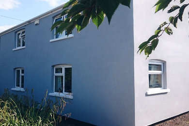 Design ideas for a country render house exterior in Other.