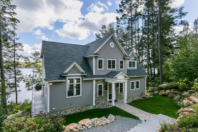 Mid-sized traditional two-storey grey house exterior in Boston with wood siding, a gable roof and a shingle roof.