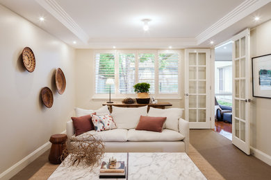 Mid-sized eclectic formal enclosed living room in Sydney with beige walls, carpet, no fireplace, no tv and brown floor.
