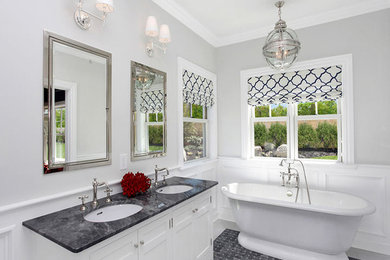 Example of a large trendy master black tile, black and white tile, gray tile and porcelain tile porcelain tile freestanding bathtub design in New York with shaker cabinets, white cabinets, gray walls, an undermount sink and quartzite countertops