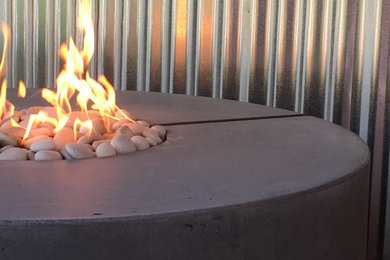 Patio - small modern backyard patio idea in Other with a fire pit and no cover