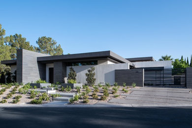 Large modern one-storey stucco white house exterior in Las Vegas with a flat roof.