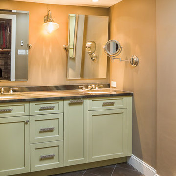 Master bath with green cabinetry and earth toned tile