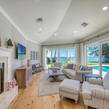 Poolside Living Room with Expansive Glass and Elegant Comfort