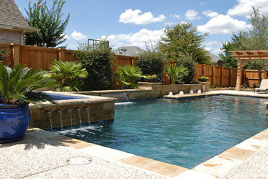 Inspiration for a large timeless backyard stone and custom-shaped lap pool fountain remodel in Dallas