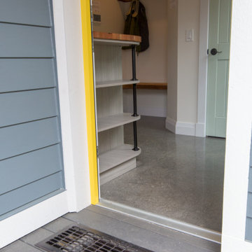Mudroom entrance with reclaimed floor grate for knocking the dirt off ye' old bo