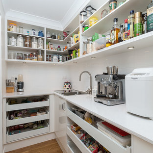Small contemporary kitchen pantry inspiration - Example of a small trendy l-shaped light wood floor kitchen pantry design in Brisbane with a single-bowl sink, open cabinets, white cabinets, granite countertops, white backsplash, ceramic backsplash, stainless steel appliances and no island