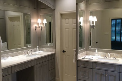 Inspiration for a large transitional master bathroom in Houston with an undermount sink, furniture-like cabinets, distressed cabinets, quartzite benchtops, an undermount tub, a corner shower, a one-piece toilet, beige tile, stone tile, beige walls and limestone floors.