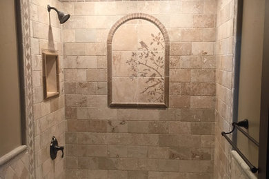 Inspiration for a small rustic stone tile limestone floor bathroom remodel in Salt Lake City with brown cabinets, a two-piece toilet and marble countertops
