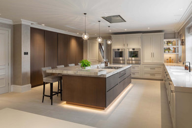 Large modern grey and brown kitchen/diner in London with a double-bowl sink, open cabinets, dark wood cabinets, marble worktops, marble splashback, coloured appliances, ceramic flooring, a breakfast bar, beige floors and white worktops.