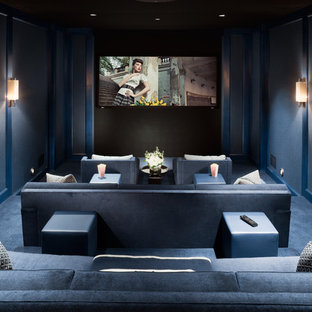 Inspiration for a large traditional enclosed home cinema in New York with blue walls, carpet, a projector screen and blue floors.
