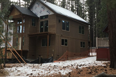 Inspiration for a large traditional three-storey brown house exterior in Sacramento with wood siding, a gable roof and a tile roof.