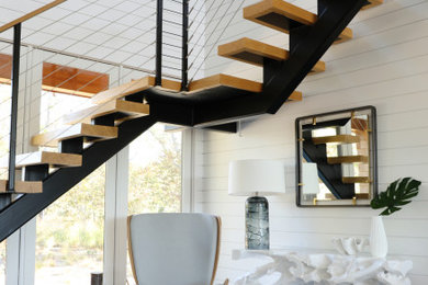 Inspiration for a large contemporary medium tone wood floor and brown floor foyer remodel in New York with white walls
