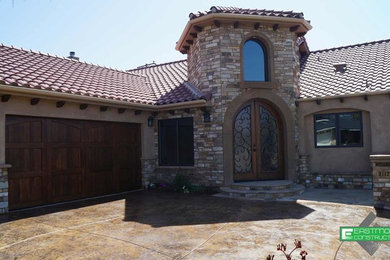Mid-sized mediterranean beige one-story stucco gable roof idea in Los Angeles