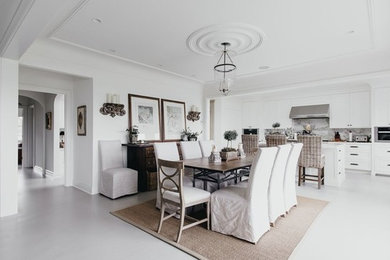 Kitchen/dining room combo - mid-sized traditional concrete floor and gray floor kitchen/dining room combo idea in Vancouver with white walls