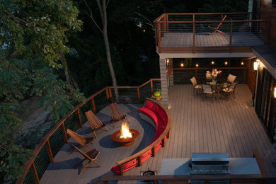 Inspiration for a large transitional backyard cable railing outdoor kitchen deck remodel in Other with a roof extension