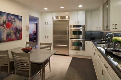 Inspiration for a large modern u-shaped light wood floor eat-in kitchen remodel in Baltimore with an undermount sink, flat-panel cabinets, white cabinets, quartz countertops, black backsplash, stone slab backsplash, stainless steel appliances and no island