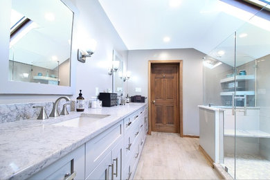 Inspiration for a mid-sized transitional master beige tile and porcelain tile porcelain tile bathroom remodel in Other with shaker cabinets, gray cabinets, a two-piece toilet, brown walls, an undermount sink and quartz countertops