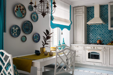 Photo of a mid-sized mediterranean l-shaped eat-in kitchen in Moscow with an undermount sink, recessed-panel cabinets, light wood cabinets, solid surface benchtops, blue splashback, mosaic tile splashback, panelled appliances, ceramic floors, no island, grey floor and white benchtop.