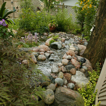 Formal Gardens in Front and Pondless Stream in Backyard