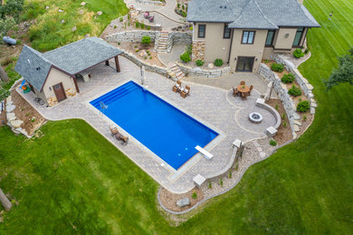 This is an example of a huge partial sun backyard brick outdoor basketball/tennis/multi-game court in Minneapolis with a fire pit for summer.