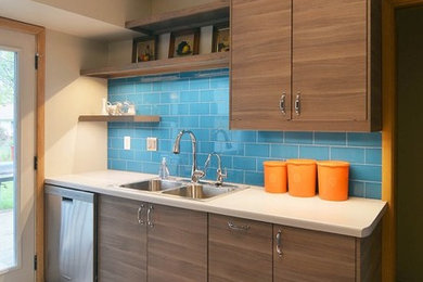 Minimalist kitchen photo in Minneapolis with a double-bowl sink, blue backsplash, glass tile backsplash and stainless steel appliances
