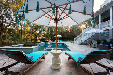 Example of a mid-sized trendy backyard stone and custom-shaped hot tub design in Charleston