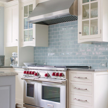 White painted cabinetry and blue backsplash tile