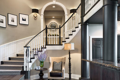 Inspiration for a large transitional wooden curved wood railing staircase remodel in Other with wooden risers