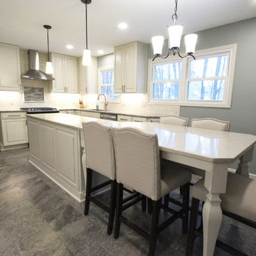 Beige Kitchen with Extra Large Island, Tile Backsplash and Granite Countertops