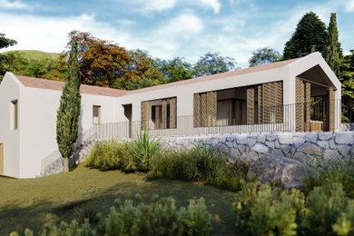 Frontal View of the L-Shaped House Nestled in Nature