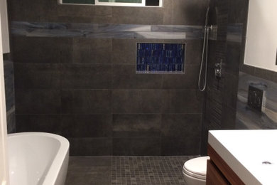 Bathroom - mid-sized modern master blue tile and ceramic tile ceramic tile, gray floor, double-sink and wainscoting bathroom idea in Orange County with flat-panel cabinets, medium tone wood cabinets, a wall-mount toilet, white walls, an integrated sink, quartz countertops, white countertops, a niche and a floating vanity