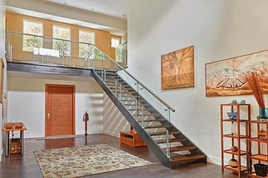 Large minimalist dark wood floor and brown floor entryway photo in Austin with white walls and a medium wood front door