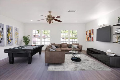Inspiration for a large modern open concept dark wood floor and brown floor living room remodel in Austin with beige walls and a wall-mounted tv
