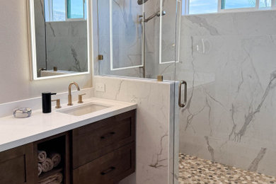 Bathroom - large transitional white tile and porcelain tile porcelain tile, beige floor and double-sink bathroom idea in Orange County with shaker cabinets, brown cabinets, an undermount sink, quartz countertops, a hinged shower door, white countertops and a floating vanity