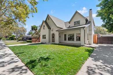 Large transitional white two-story brick and board and batten exterior home photo in San Francisco with a shingle roof and a gray roof