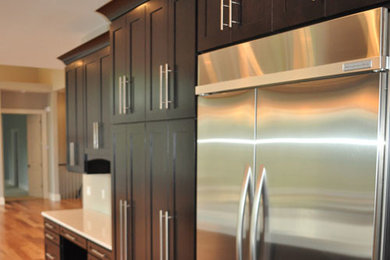 This is an example of a contemporary kitchen in Other with light hardwood flooring.