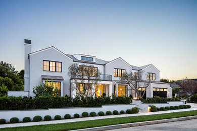 Large transitional three-story mixed siding house exterior photo in Los Angeles